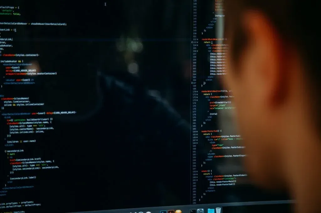 Man looking computer screen with code, sql group by