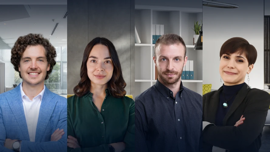 Four instructors on the Senior data analyst Career Track stand side by side in a modern office setting, professionally dressed, facing the camera and smiling.