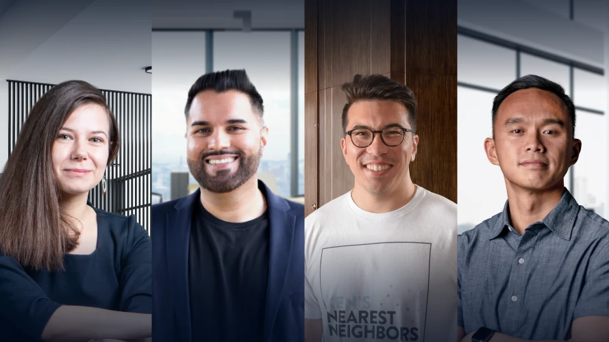 Four instructors on the Senior data scientist Career Track stand side by side in a modern office setting, professionally dressed, facing the camera and smiling.