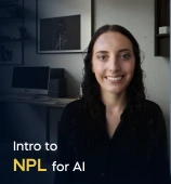 The Intro to NLP for AI course creator stands in a modern office setting with the text 'Intro to NLP for AI' on the left side of the image.