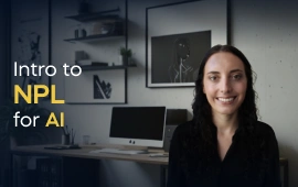 The Intro to NLP for AI course creator stands in a modern office setting with the text 'Intro to NLP for AI' on the left side of the image.