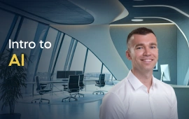 The Intro to AI course creator stands in a modern office setting with the text 'Intro to AI' on the left side of the image.