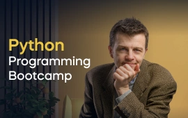 The Python Programmer Bootcamp course creator stands in a modern office setting with the text 'Python Programmer Bootcamp' on the left side of the image.