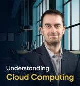 The Understanding Cloud Computing course creator stands in a modern office setting with the text 'Understanding Cloud Computing' on the left side of the image.