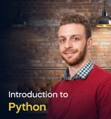 The Introduction to Python course creator stands in a modern office setting with the text 'Introduction to Python' on the left side of the image.