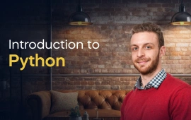 The Introduction to Python course creator stands in a modern office setting with the text 'Introduction to Python' on the left side of the image.
